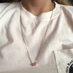 Gold necklace with geometric charms